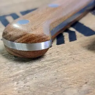 BBQ-kniv Kockkniv BBQmonster - robust kniv/cleaver med slida i läder. 5mm grov rygg och en vikt på 400 gram En bbq-kniv för BBQ och Grillning: BBQmonster BBQ-kniv / cleaver är kniven som är en kombination av en rejäl kockkniv och en Cleaver / köttyxa, och med denna i din hand är inte en kotlettrad eller ett revbensspjäll säkert någonstans. Bladet är EXTREMT stabilt och viker inte även vid hårdare tag. Ryggen är hela 5mm tjockt och större delen av bladet har en härlig hammrad yta som kniven rejält "intstagramvänlig" och photogenique. Denna BBQkniv kommer en slida av läder vilket gör att du kan bära den i din livrem eller i ditt förkläde. Skaftet är av polerat och lackat hårdträ och detta omsluter det genomgående knivbladet avslutning. Skaftet ger ett bra grepp och är enkelt att rengöra. Handtaget passar både höger- och vänsterhänta. Kolstål med blandning X50CrMoV15 Hårdhet 56° HRC vilket är ett relativt mjukt stål - något som gör att du själv enkelt kan hålla din kniv vass. Total längd: 29 cm Längd på bladet: 18 cm Längd på skaftet: 11 cm