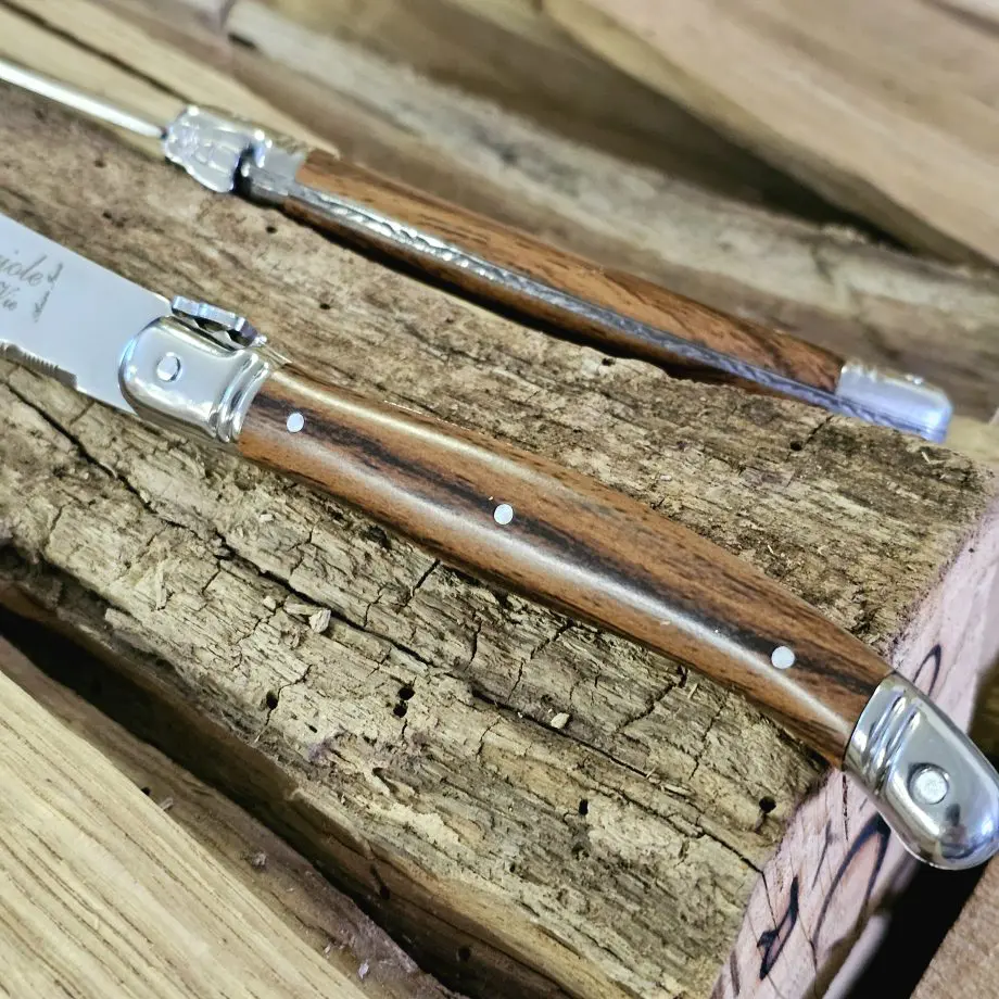 Köttknivar Laguiole Wood - 6pack köttbestick - eleganta bestick som skär snyggt kommer med vackert knivställ av trä Laguiole Wood köttknivar är lika fina att skära med som de är vackra att duka med. Du köper dessa i 6-pack och de kommer med ett vackert förvaringsställ av trä - de kan med andra ord stå framme utan att skämma ut sig. Här har du den perfekta presenten till dig själv eller en annan köttälskare som uppskattar både effektiva knivar att skära med och som gillar den eleganta och tidlösa designen som Laguiole står för. Laguiole Besticken har ett detaljerat och vackert handtag som ligger bra i handen. Handtag och knivblad har samma längd 12cm + 12cm, vilket ger knivarna en perfekt balans. Eggen är mycket fint tandad vilket gör att du utan problem skär fiber för fiber med raka snygga snitt. Dessa köttbestick bör diskas för hand även om de är klassade att tåla maskindisk (dock är maskindiskmedel ofta mer blekande och tärande på material med mycket detaljer - som dessa knivar har). I förpackningen ingår: 6 stycken eleganta Laguiole köttknivar 1 styck knivställ / knivblock i trä