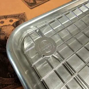 Cooling rack Large - Avsvalningsgaller - 32,5cm x 30,5cm - låt köttet vila effektivt på detta galler av rostfritt stål, skräddarsytt för våra egna aluminiumbrickor Cooling rack Large är vårt egna, extremt stabila och välbyggda avsvalningsgaller för vår kylskåpsanpassade aluminium-bricka. Rostfritt stål som håller år ut och år in. Som på alla andra produkter som vi är extra stolta över bär också detta galler vår logo  - ett mynt, eller ett logo-coin som vi kallar det, fast-svetsat uppe i en hörnet. Med Cooling rack Large skapar du luft under köttet och processen med att vila ner köttet (ex. brisket eller pulled pork karré) ned mot 70 grader går därmed snabbare.