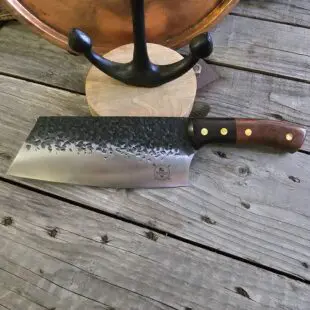 BBQ-kniv / kockkniv "Anchor #20" 31cm lång kökskniv i cleaver-format - snyggt hamrat blad och skaft av ädelträ- galet vass - liknande knivar säljs för det tredubbla på andra sidor! BBQ-kniv / kockkniv "Anchor #20" är en kökskniv i format av en cleaver men vass som en kockkniv. Kniven är utmärkt både för att skära jämna skivor och hacka ner örter och grönsaker. Söker du en serie av välarbetade och lättskötta kockknivar? Ta en kik på BBQmonsters egna serie knivar! Samtliga knivar i serien kommer i en svart presentförpackning med BBQmonsters sigill "Make BBQ great again" tryckt på locket. Knivarna från BBQmonster har även BBQmonsters logo ingraverad på bladet. Vi sätter bara vår logo på prylar som vi verkligen tycker om - detta är en sådan.