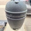 Kamado Bastard Urban Large (49cm) 2022 års modell med delade galler med två nivåer - multi level  - våldsamt snygg och välbyggd keramisk kamado - livstids garanti på keramiken Se upp för billiga kopior och oseriösa ÅF - detta är den äkta Bastard Kamado med Livstids garanti på Keramiken. Det har tyvärr blivit vanligt att online-butiker (ingen nämnd ingen glömd) säger sig sälja bland annat Bastard Kamado och Kamado Joe till priser långt under rådande prislista - priser i nivå eller under nettoprislistan. Hur är det möjligt eller rättare sagt - är det möjligt att det stämmer - Nej. Så länge företaget inte "erbjuder" dig att betala "svart"  är det såklart en orimlig affärsidé (tyvärr har dock kunder varit med om detta ofog så se upp). Kunder rapporterar att det inte sällan är lockpriser för att du som kund skall lägga din order. Väl i händerna väntar inte sällan ett besked att produkten du köpt är slut men att du nu istället kan "åtnjuta" en finfin rabatt på en kamado som är minst lika bra... Nope, inte idag heller. Så var på din vakt. Hos BBQmonster kan du känna dig trygg med att du inte kommer att hamna i kläm, finns den i lager kan du hämta den samma dag, du får såklart ett kvitto så att du kan registrera din Kamado för att som förstagångs köpare erhålla din personlig livstidsgaranti (den gäller alltså ej för andrahandsköparen). Beställer du på webben skickas Kamadon från vårt eget lager och du har den inom 1-3 dagar beroende på vart i landet du bor och när på dagen som din beställning når oss. Om Bastard Kamado byggd av den extremt värmetåliga mineralen Cordierite med livstids garanti! tålig glasfiberpackning - snyggare och bättre än filt kommer som standard med kolkorg och asklåda för enkel tömning 49cm galler (2cm större än ex Kamado Joe Classic och BGE Large) Rostfria halvmånar - 2 galler i hela 7 mm stål (!) Robust benställning med en vikt på runt 15 kg och lättrullande svarta hjul Delade deflektorstenar där ena sidan är glaserad för enklare rengöring (smart!) Regnsäker precisions toppventil av gediget gjutjärn Enkel montering 136 kg kärlek av matt mörkgrå keramik Kamado Bastard Urban Large är förmodligen marknadens just nu snyggaste Kamado koncept. The Bastard är ett Holländskt företag som verkligen gått all in på att ta fram en kamado med ett tillhörande koncept som står både för kvalitet och en design som slår det mesta. Urban kallas denna färg, en matt kulör som i vissa lägen ser mörkgrå ut, nästan svart och i andra mer åt militärgrönt - tänk Camouflage - en kameleont, - en bastard om du så vill. Kvalitetskänslan finns där från uppackning och unboxing hela vägen till sista rostfria muttern sitter på plats. BBQmonster slås av det härliga tänket att man från första sekunden blir lite smått kär i  Bastard kamado Konceptet: du möts av en svart påse märkt med "first aid kit" här finns starten för monteringen och resan börjar. Allt är sobert, rejält och vi tjatar gärna om det: snyggt!  Bilder som är självklara, och om du hellre ser en film om själva monteringen så scannar du QR-koden och löser det den vägen. Skuvar och muttrar söktes av med magnet och alla väsentliga delar är icke magnetiska - något som talar för att dessa är riktigt rosttröga eller rostfria. Bilderna i manualen gör att man inte vill vänta med att få upp bastarden, igång med kolen och på med köttet - det rycker i grilltarmen från första stund. Yttre Det första som man slås av är den imponerande "mankhöjden" 95cm - den är lika hög som en Big Joe! Mest troligen har det Holländska teamet haft i tanken att folket i nederländerna är det befolkning som har högst medellängd i världen. Detta ger dig en bra och ergonomisk arbetshöjd. Totala höjden från golvet till toppen är 135cm - Bastard Kamado Urban ser i det närmsta ut som en general där den står i skimmer av grön/grått och en matt sober look. Nya modellen för 2022 har ett ännu mer balanserat lock (dome) vilket gör att du behöver mindre lyftkraft för att lyfta det och det stänger sig mjukare än föregångaren (även om du inte skall släppa ner locket!) Materialet Cordierite är en mineral som används som smycke men framförallt i tillverkning av produkter som behöver kunna motstå extrema temperaturer. 800 grader Celsius kommer du aldrig att komma upp till i din Bastard Kamado men det kan kännas tryggt att den skulle klara om låt säga solen skulle få ett våldsamt utbrott, en vulkan i närheten skulle svämma över - eller liknande...skämt å sido - det skadar i alla fall inte. Benställningen är mycket rejäl och står på lättrullade hjul varav två är låsbara. Pulverlack skyddar mot rost. Skruvar brickor och muttrar är i rostfritt och överlag är grymt rejält från början till slut. Monteringen av benställningen är logisk och enkel och man känner att kvaliteten är A+. Skorstenen är  en nyskapelse byggd av gjutjärn. Vikten ligger över 1 kg så vi pratar om rejält gods som kan ta hettan. Toppen är inte den klassiska med stora hål som kan täckas genom ett roterande hjul, utan en topp som till 90% är täckt och skyddad mot regn och nederbörd, luften hittar nämligen sin väg ut i kanten av toppen. När du vill ha fullt flås och maximal temp så lyfter du helt enkelt bort den översta toppen. Det är så du styr tempen - ju mer luft som susar igenom din kamado desto högre temperatur kommer du att uppnå. Det stora reglaget för tempen är den nedre öppning. Fullt öppet = full fart på luften = mer syre = högre temperatur. Inre Kamadon har ett känt och beprövat inre där fireboxen är försedd med ett sågat spår samt också delad i två delar på höjden, allt för att minska risken för sprickbildning av inre keramiken. Kamado Bastard har delade galler (halvmånar) av rostfritt stål, med en sammanlagd diameter på 49cm som ståtar med hela 7mm grovlek! Detta gör att bara gallret i sig väger flera kilo. Gallret kan placeras i två olika nivåer = Multi-level cooking rack  Under gallret finns en hållare för att placera en eller två av de halvmåneformade deflektorstenarna. Dessa stenar är glaserade på ena sidan vilket gör att keramiken inte absorberar fett och dropp som annars lätt letar sig in i keramiken (med risk för sprickbildning som följd). Bastard Kamado kommer med en smart asklåda som placeras under den mycket robusta  och höga kolkorgen som ingår i priset. Kolkorgen förbättrar förbränningen och ger en luftspalt mot keramiken även om du "toppar" den med kol (ex vid pizzabakning). Även vid low & slow och BBQ rökgrillning så har du nytta av korgen - mer syre runt kolen gör det enklare att få till rätt rök - thin blue smoke istället för brandrök. Packningen som sitter på The Bastard Kamado Large är av det moderna snittet - glasfiber. Glasfiber håller bättre än filt och det minskar även risken att packningen fryser ihop under den kalla delen av året. Kamadokroppen är något högre än standard 47cm kamados vilket gör att du kan hantera flare ups bättre, samtidigt som den högra kolkorgen öppnar upp för riktigt het och nära searing när så önskas. På sidorna sitter fällbara sidobord av mörkbetsat trä, stora och rejäla - även dessa större än de flesta andra sidobord.